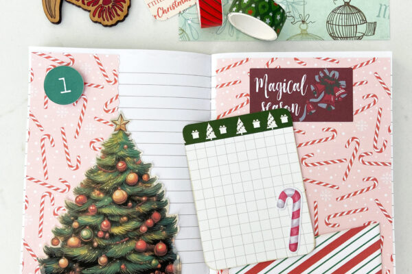 December Daily Junk Journal open to Day 1 decorated with candy canes paper, Christmas tree, pocket and journaling card.