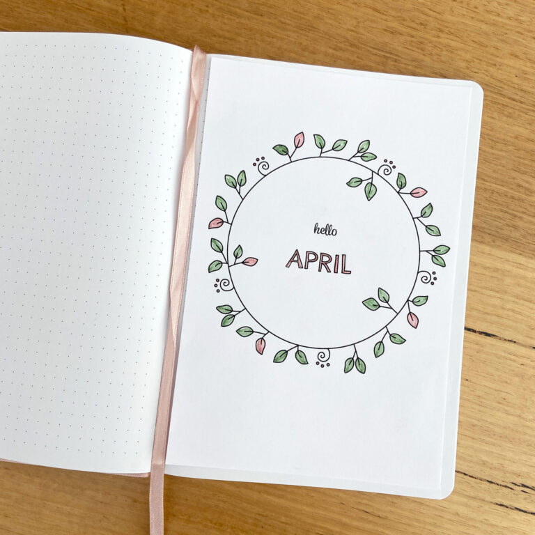 Printable April Monthly cover page featuring hand drawn wreath with little leaves and swirls, inside dot grid bullet journal