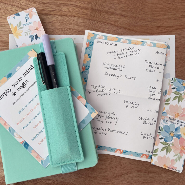 My notebook with a filled-in braindump page, bookmarks and Braindump Quick-Start Prompts card