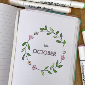 October cover page in notebook, coloured in with pastel alchohol markers
