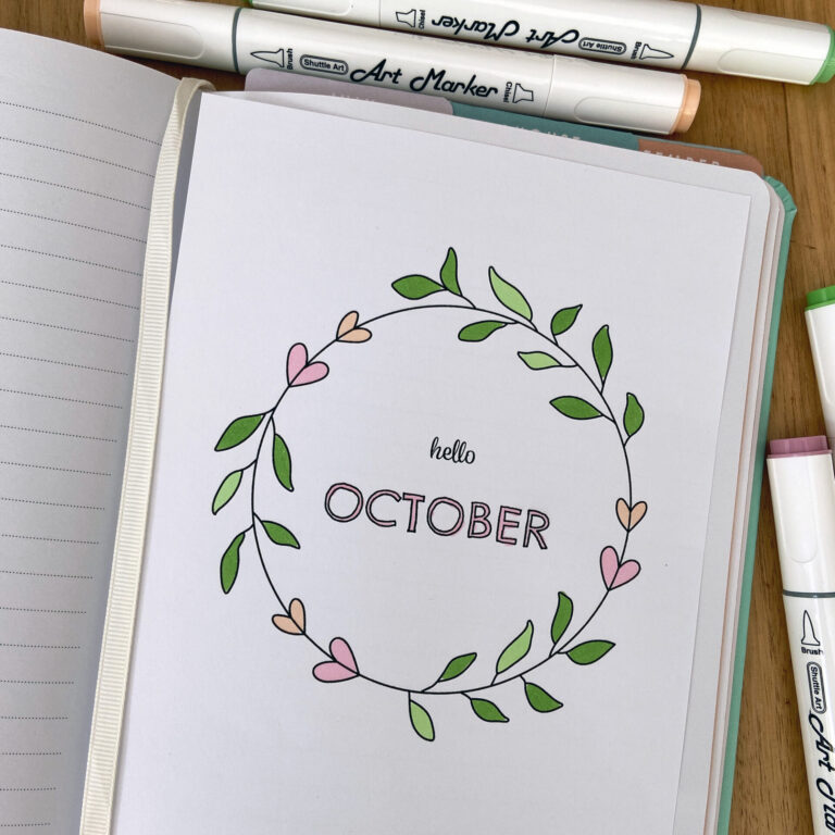 October cover page in notebook, coloured in with pastel alchohol markers