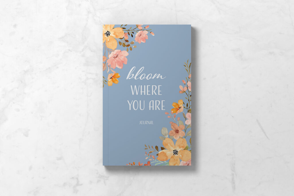 Perimenopause journal showing front cover in light blue with delicate floral design and the words Bloom Where You Are.
