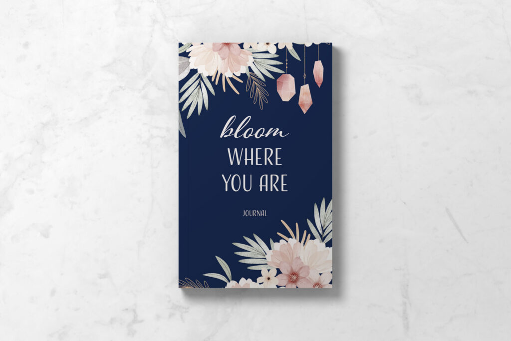Perimenopause journal showing front cover in navy blue with crystals and flowers, and the words Bloom Where You Are.