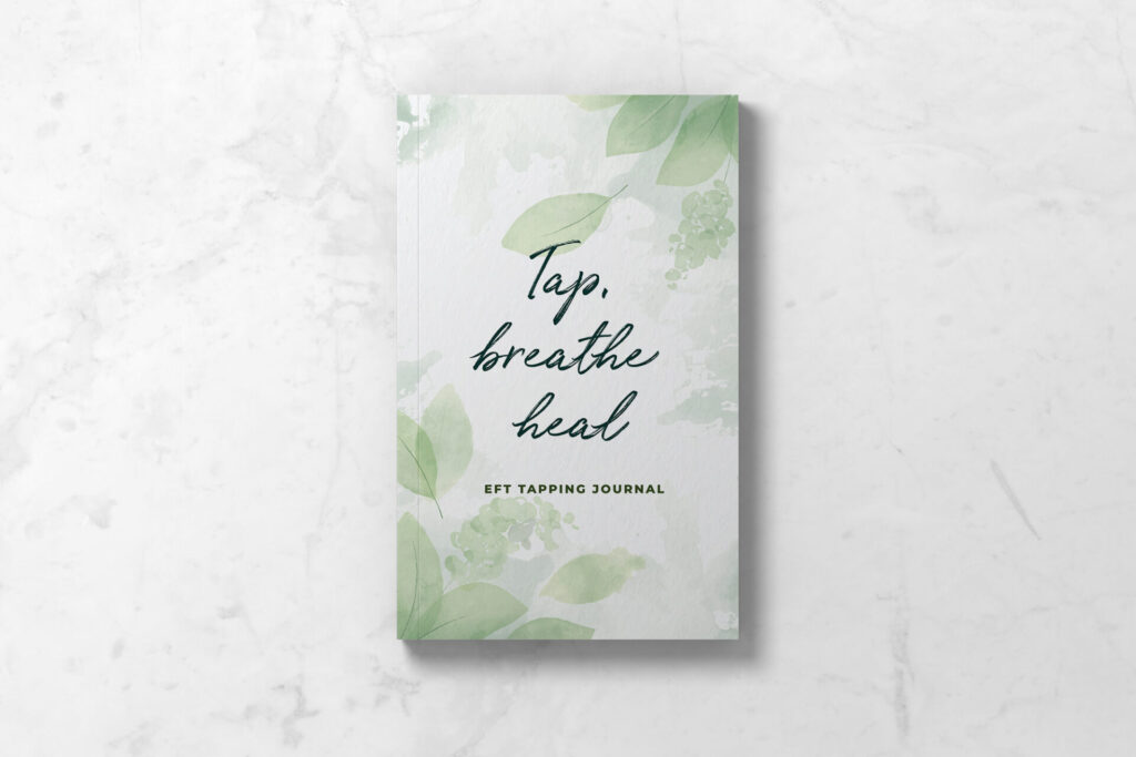 Front cover of EFT Tapping Journal featuring soft watercolor leaves and the wording Tap, breathe, heal.