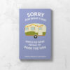 Travel journal front cover with purple background, cute vintage caravan, and the words "Sorry for what I said while we were trying to park the van".