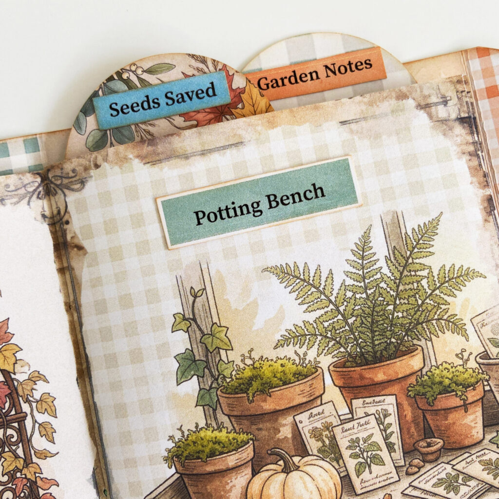 A word strip in sage green attached to a junk journal page, reading "Potting Bench". Two labels are attached to the top of the pages as little dividers for journal sections.